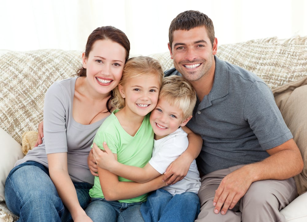 Happy family sitting on the sofa at home