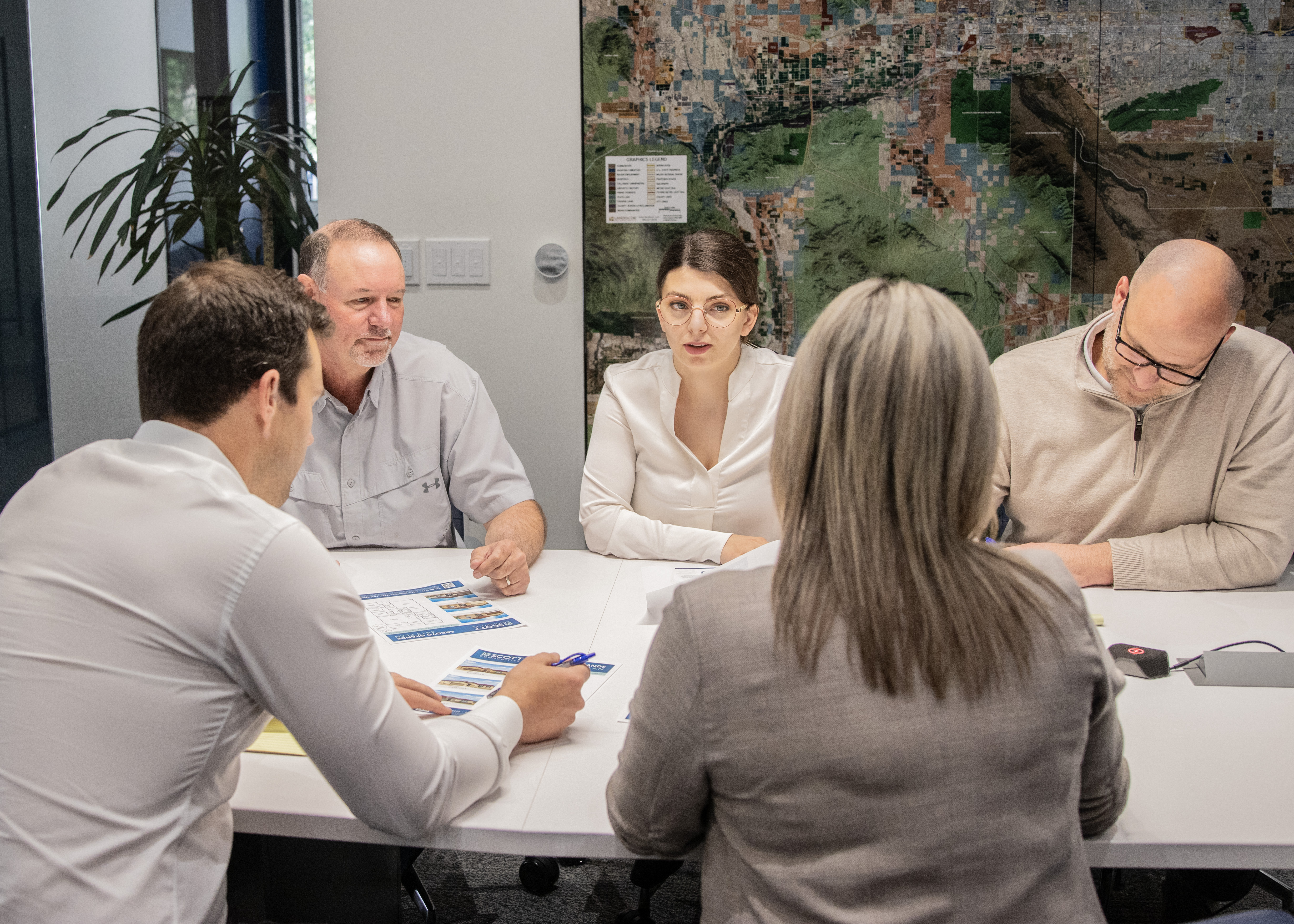 Corporate executives around a conference table during a planning meeting