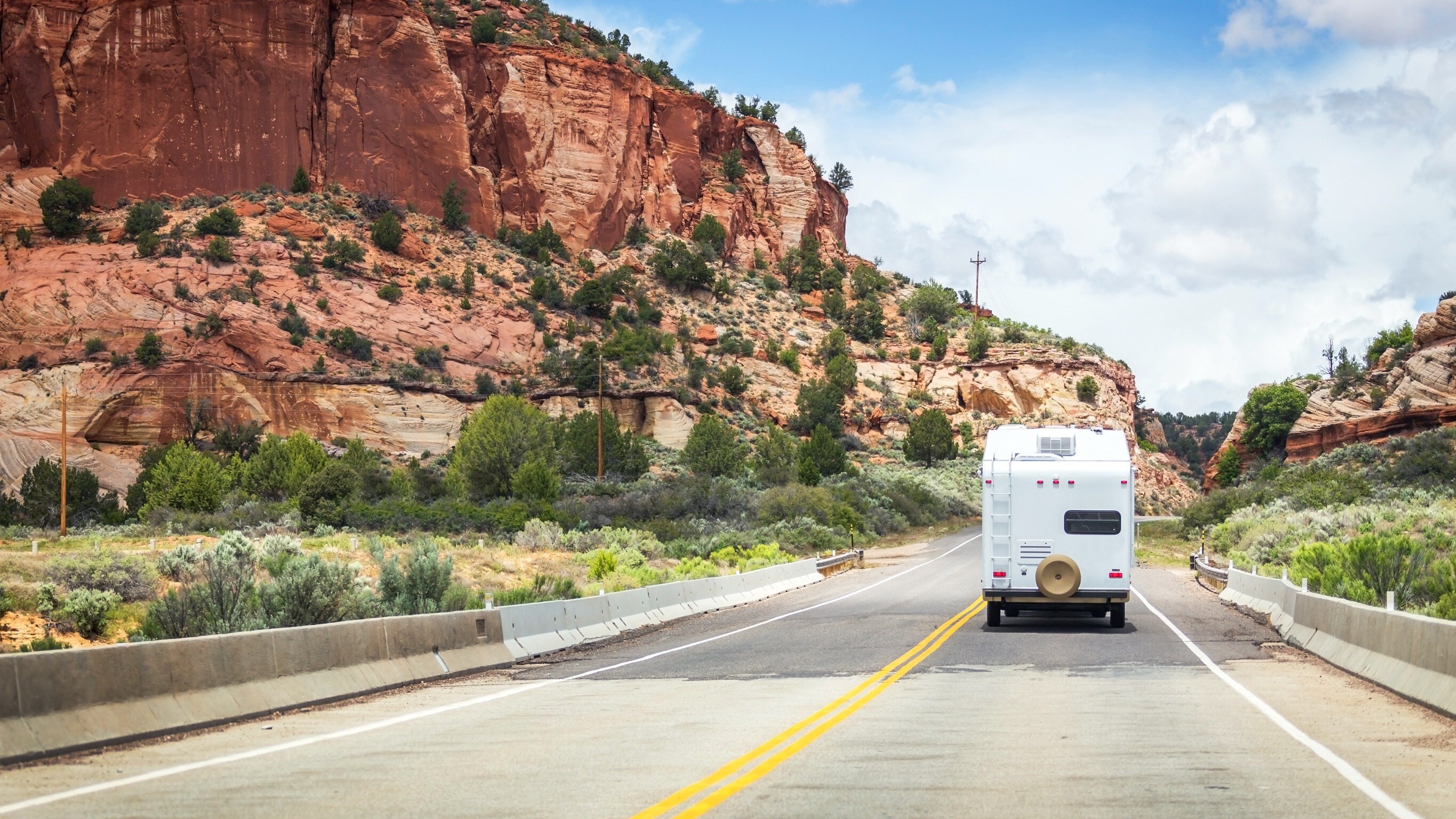 RV driving through monument valley